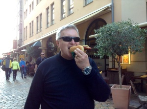 Wayne enjoys a bratwurst from a street vendor in Dresden.